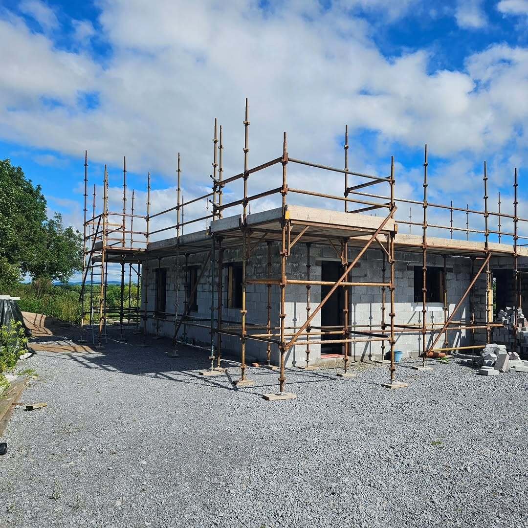 Single-storey blockwork new build in Limerick wrapped in scaffolding with a concrete floor slab in place