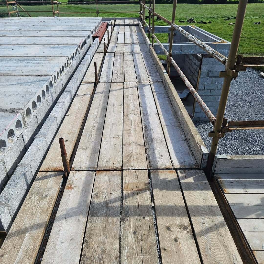 Scaffold walkway beside hollowcore floor units on blockwork walls in rural Limerick