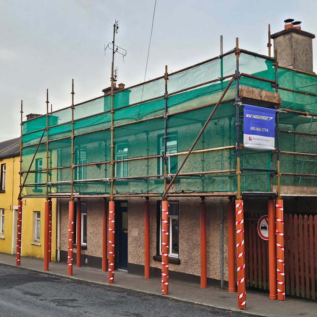 Close view of MacIndustries scaffolding, green netting, and site banner on Barton Street, Wicklow